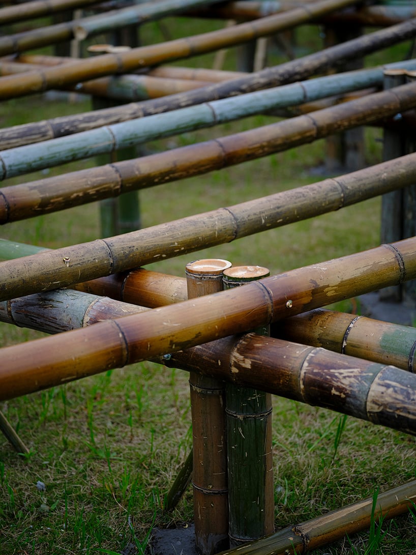 SODA architects plants bamboo stage installation amid mountains for qingshan art season