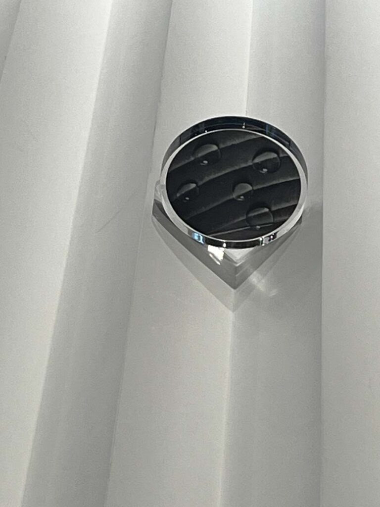 Detail, Alexandre Arrechea, abstracted agrarian field with glass discs to represent water drops.