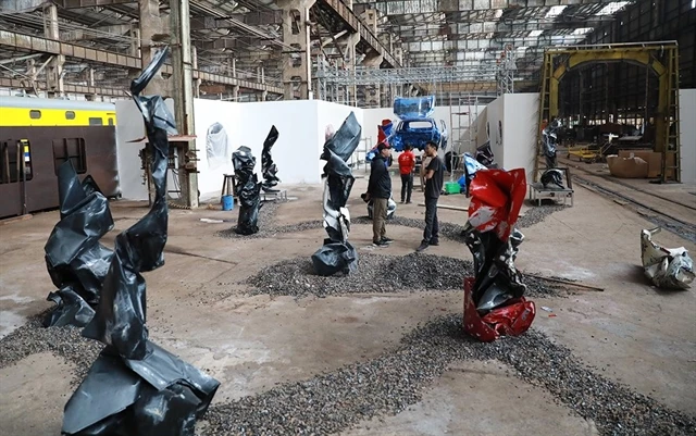Artworks made from old bonnets and car body panels by artist Trinh Minh Tien are on display at his exhibition Thuy Phu (Water World) at the Gia Lam Train Factory.