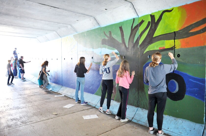 Students painting a mural