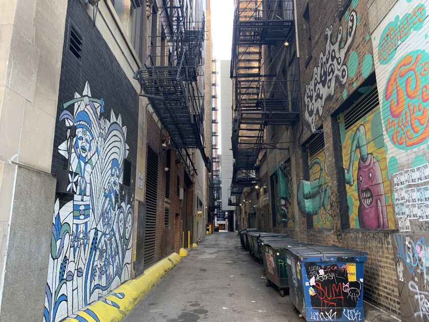 Murals discovered in a South Loop alley, including the one at left by ZorZorZor.