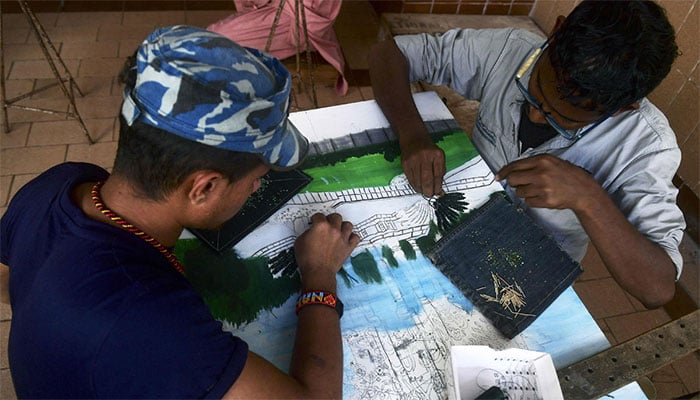 Inmate prisoners learn to embroider at the central jail in Karachi on December 16, 2023. — AFP