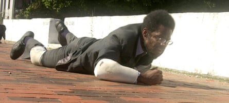 William Pope.L crawls along a Portland sidewalk as a way of creating empathy for those who live in a horizontal world as homeless and downtrodden souls.