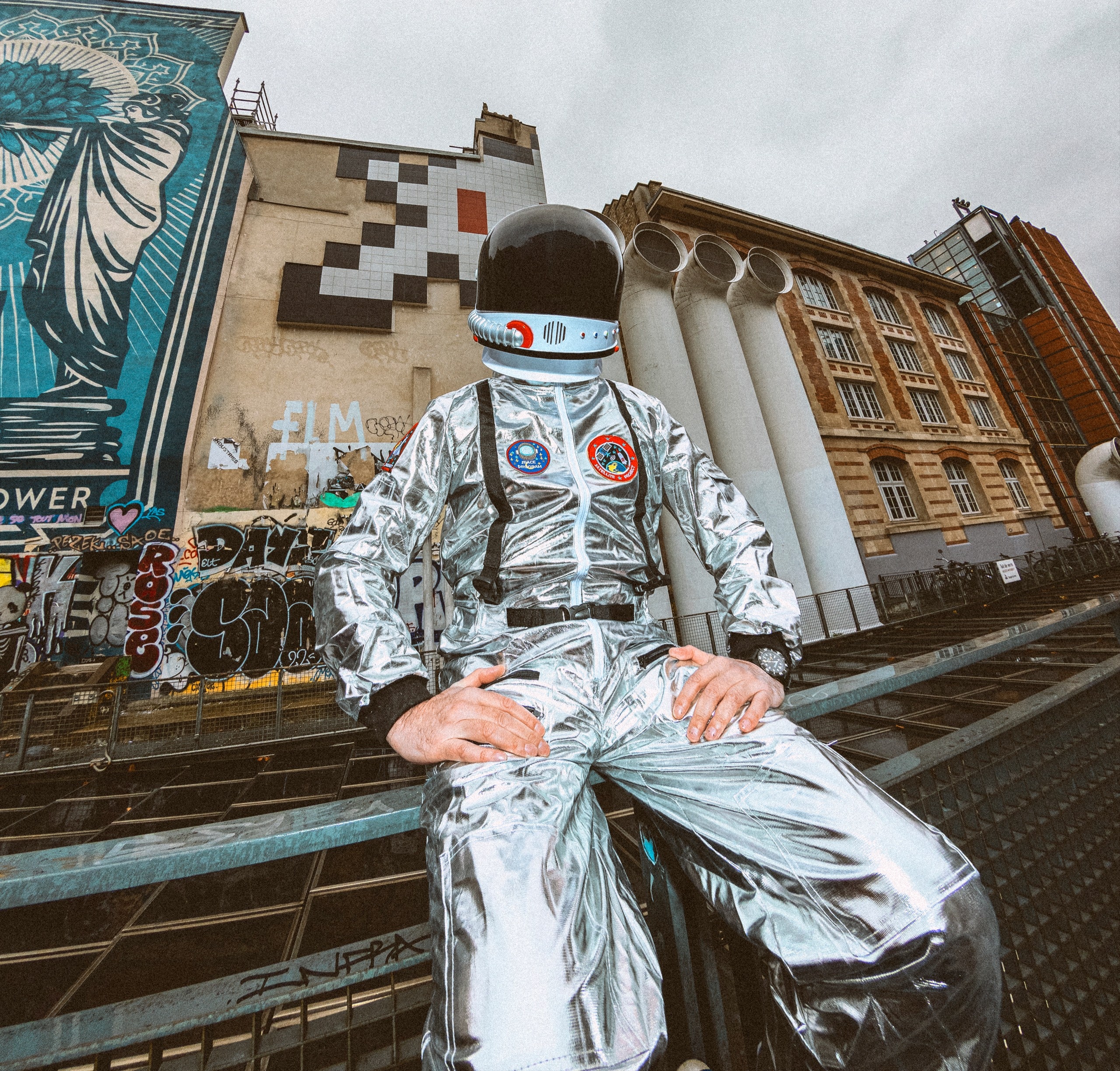 Invader photographed in a shiny spacesuit by Lou Escobar.