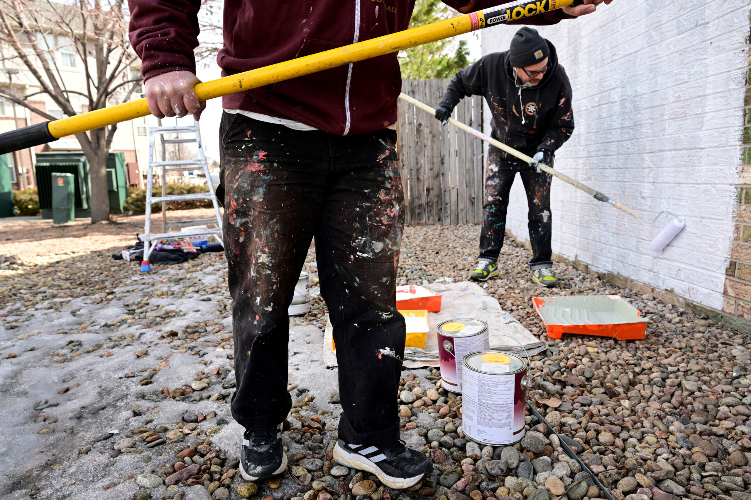 Muralists Pedro Barrios, left, and his partner Jaime Molina, right, put a base layer of white paint to prime a brick wall for their mural project for Novo Legal Group at 4280 Morrison Road in Denver on March 3, 2023. (Photo by Helen H. Richardson/The Denver Post)