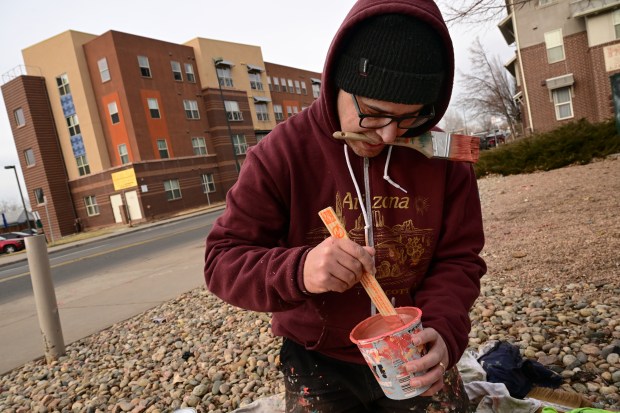 Muralist Pedro Barrios mixes paint for his mural project for Novo Legal Group at 4280 Morrison Road in Denver on March 10, 2023. (Photo by Helen H. Richardson/The Denver Post)