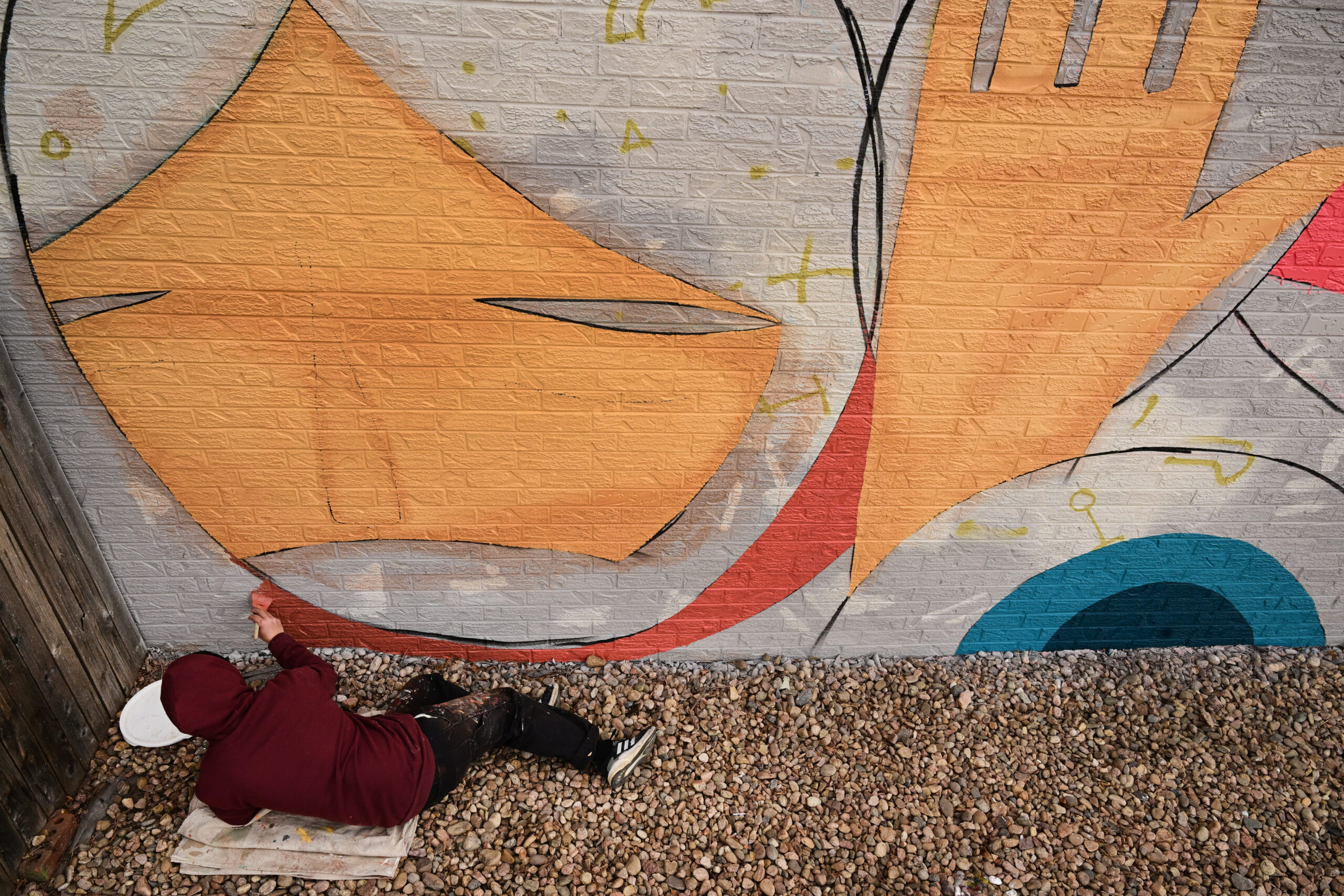 Barrios works on his mural project for Novo Legal Group at 4280 Morrison Road on March 10, 2023 in Denver.