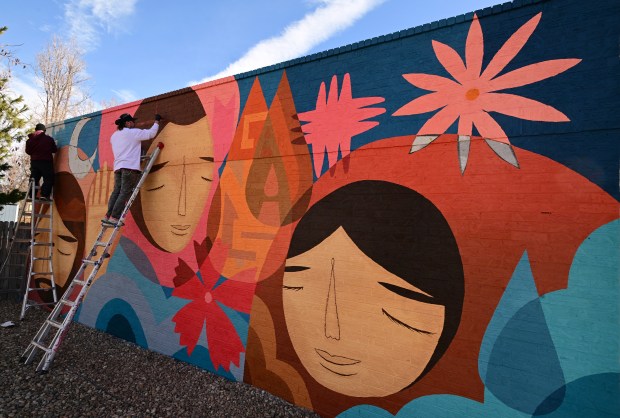 Muralists Pedro Barrios, left, and his partner Jaime Molina work on their mural project for Novo Legal Group at 4280 Morrison Road on March 14, 2023 in Denver. The two artists, who own Barrios & Molina LLC, specialize in all styles of murals from large scale projects on multi-story buildings to smaller projects for local businesses in the Denver area.