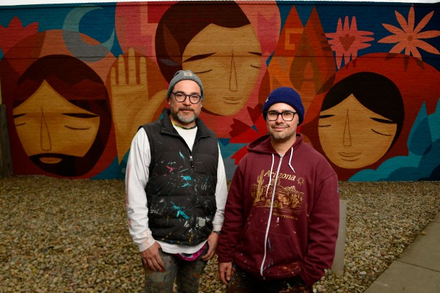 Muralists Jaime Molina, left, and Pedro Barrios stand in front of their completed mural on March 15, 2023. (Photo by Helen H. Richardson/The Denver Post)