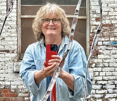 Carolyn Bates with Aaron Grossman mural at 412 Pine Street - COURTESY