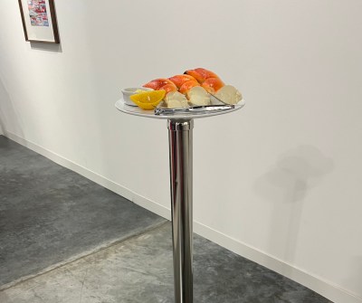 An imitation stone crab spins on a metal pole beside a lemon.