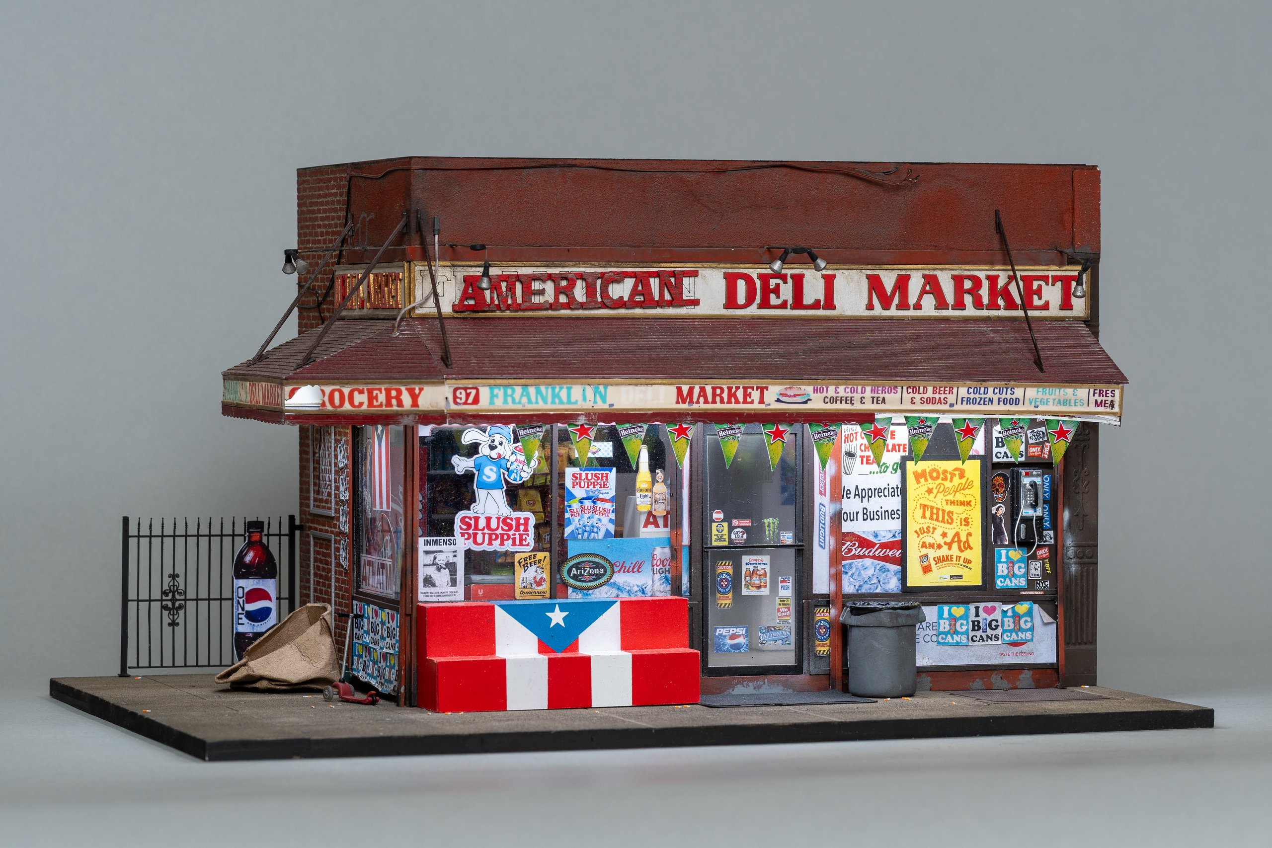 A scale model of a corner shop with a sign that reads 