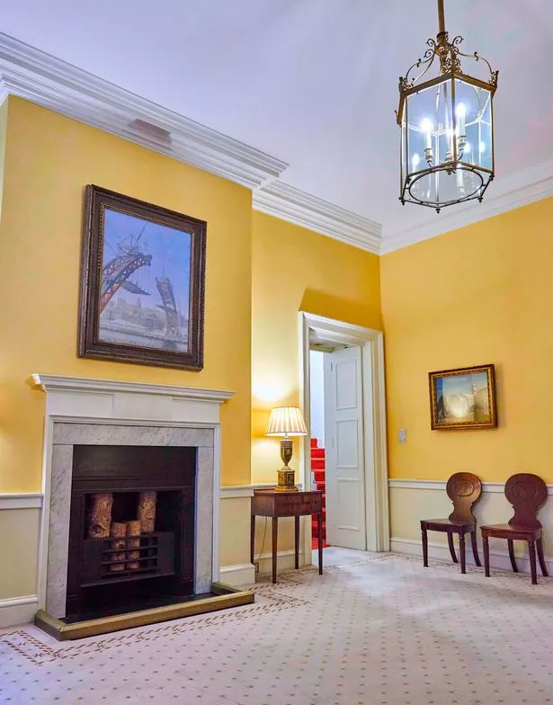 The painting The Building of the Tyne Bridge by Edward Dickey, from the Laing Art Gallery, is seen hanging in a prominent position above a fireplace in a lemon-colour room inside 10 Downing Street. © Crown Copyright, UK