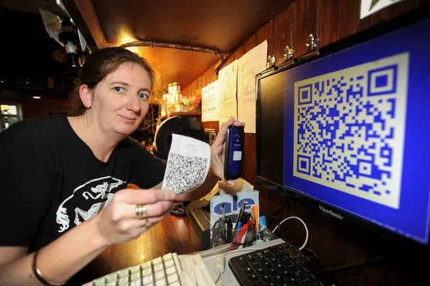 Liz Jeffries, manager of Haymakers pub, High Street Chesterton, showing Bitcoin in operation on her till