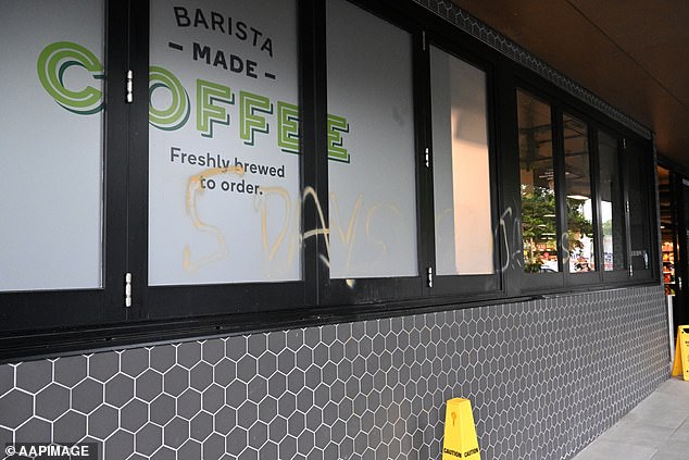 Vandals spray-painted the message: '5 days 26 Jan Aussie Aussie Oi Oi Woolies f*** u' on the front of Woolworths Metro store in Teneriffe, Brisbane (pictured)