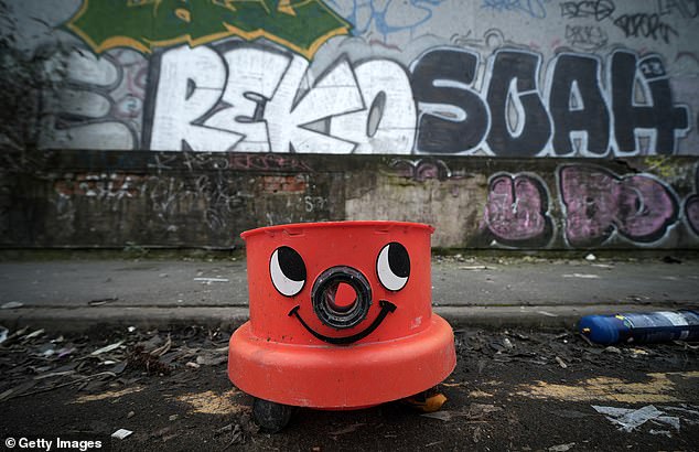 A broken Henry hoover was dumped alongside the rubble