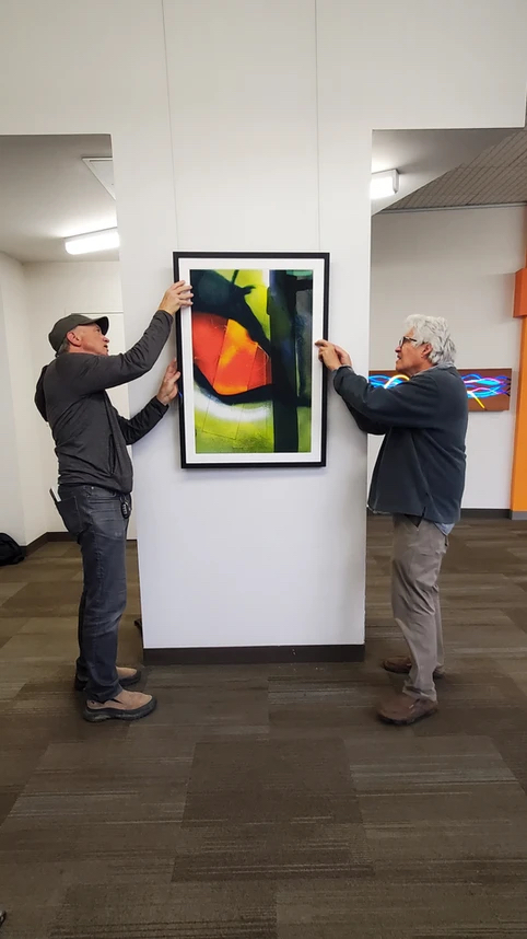 Kline hangs one of his pieces, titled 