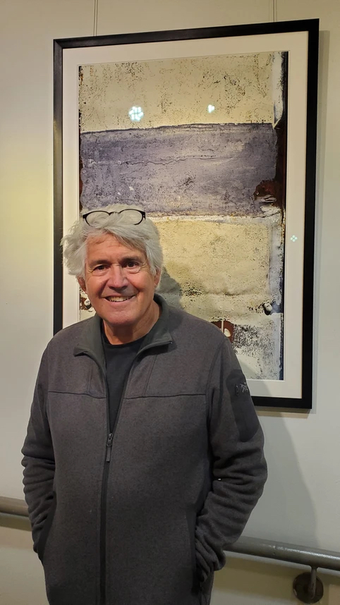 The artist, pictured here with one of his photographs from the 