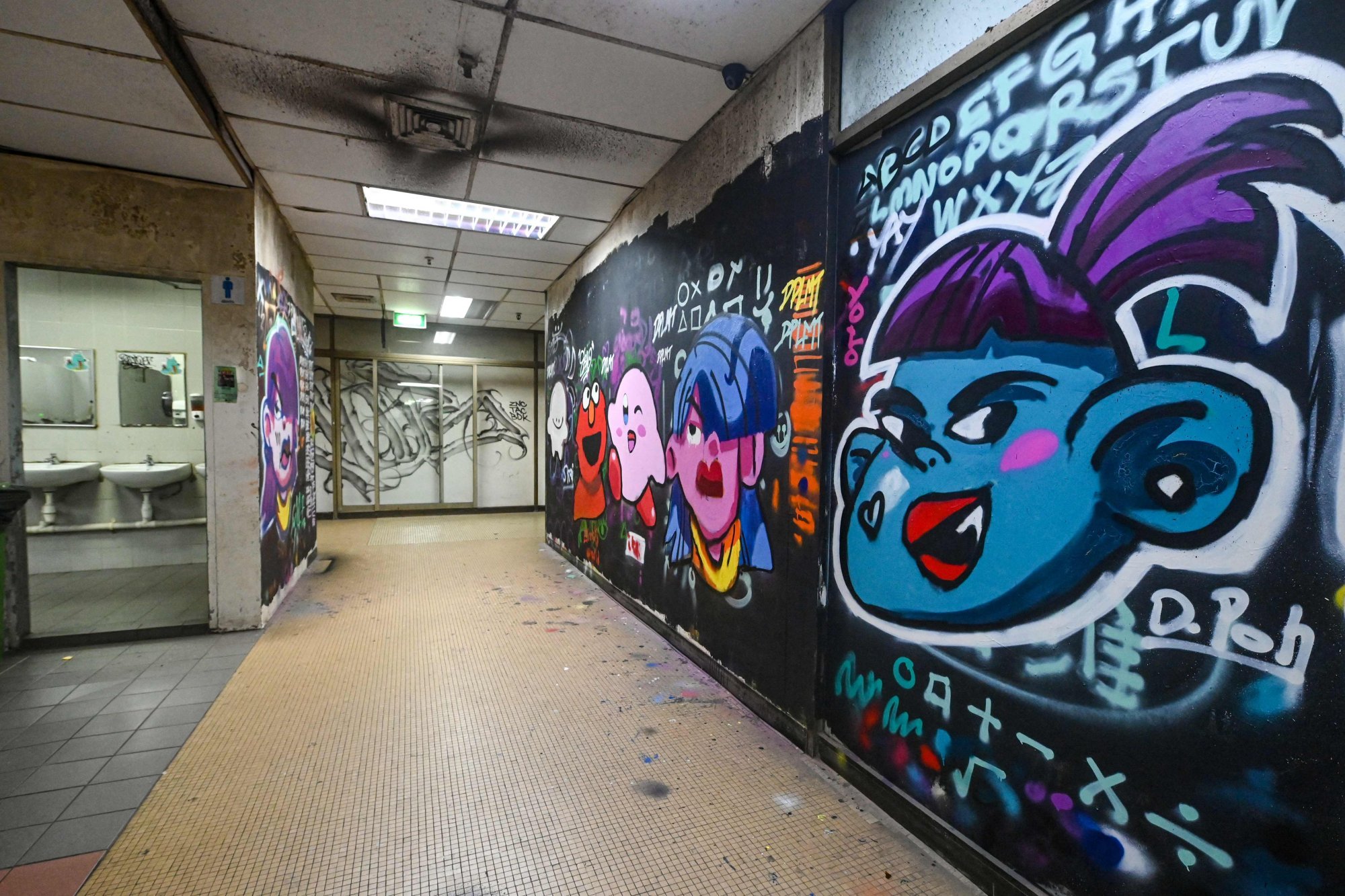 Murals and graffiti on the walls inside the Peace Centre in Singapore. Photo: AFP