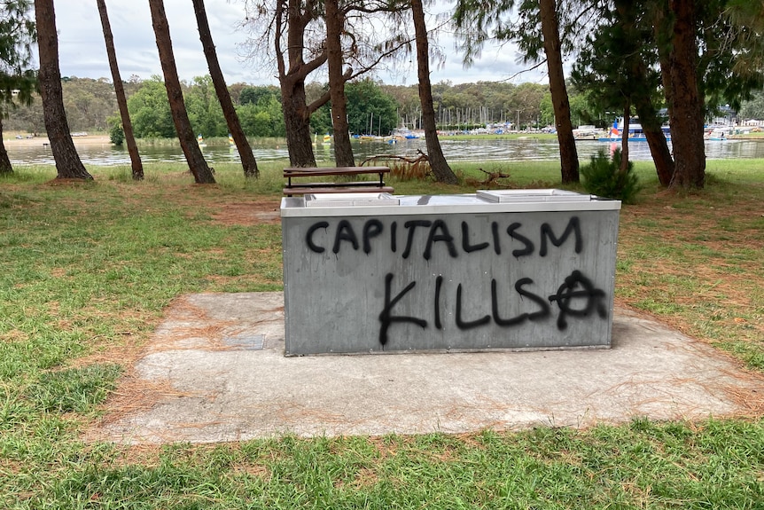 Graffiti on a BBQ that reads: Capitalism kills.