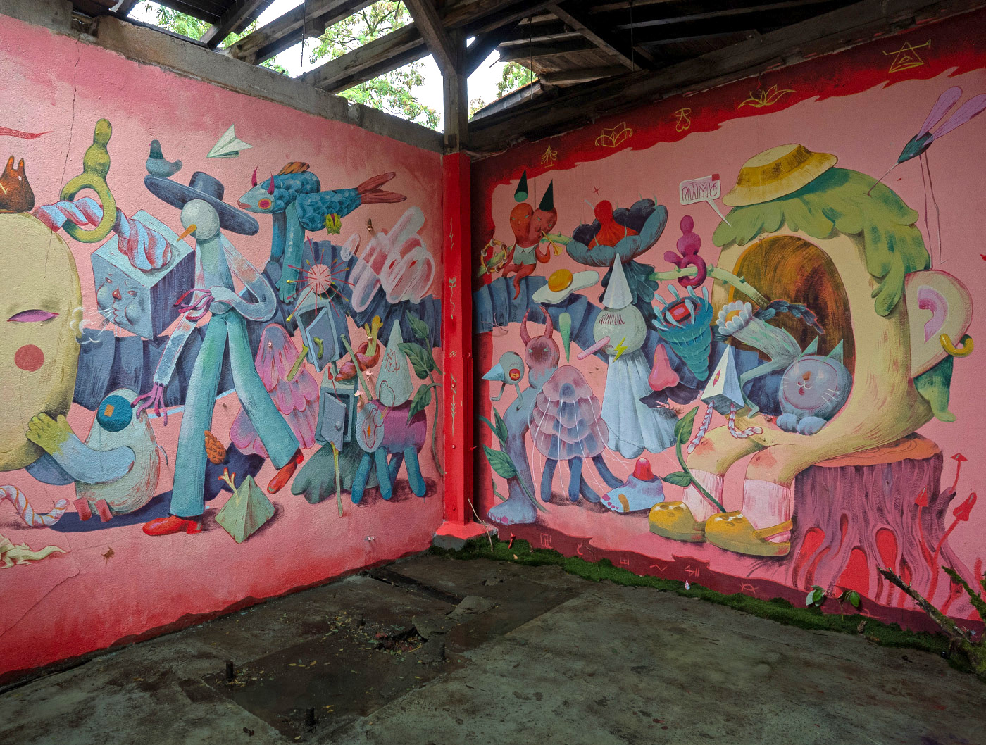 Two walls inside a dilapidated space featuring surreal creatures on a pink background.