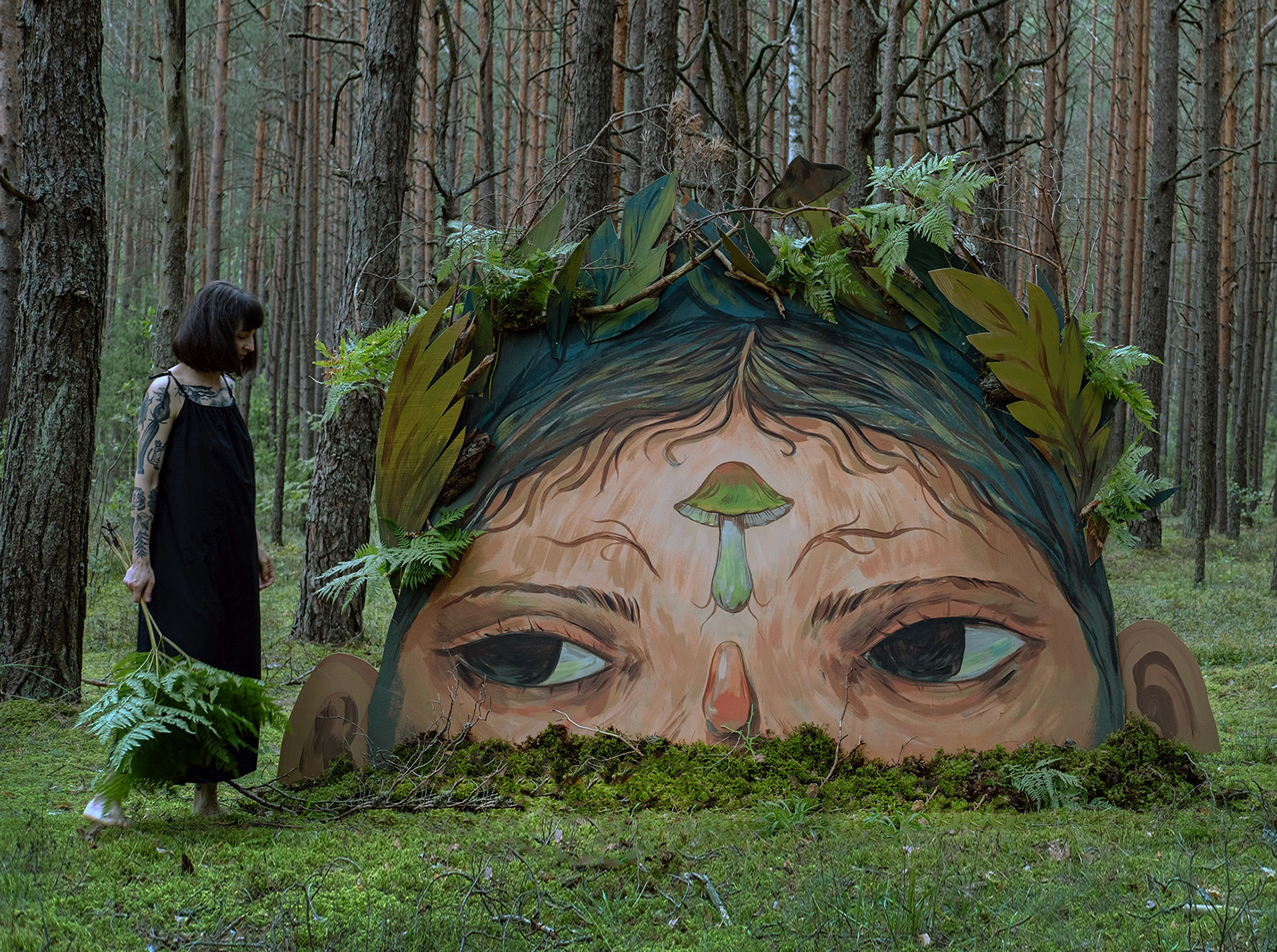 A painted panel of a figure in the forest who appears to be popping out of the mossing ground.