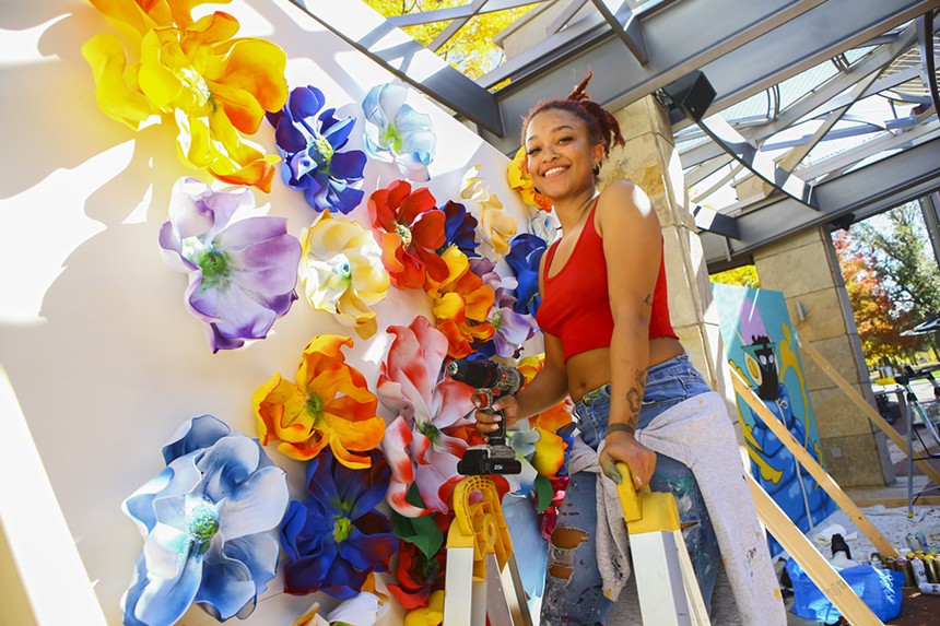 woman painting a mural