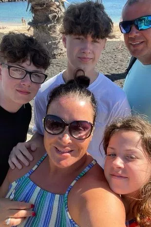 Paul and Melody, 45, with their kids Elis, Ewan and Evie on holiday