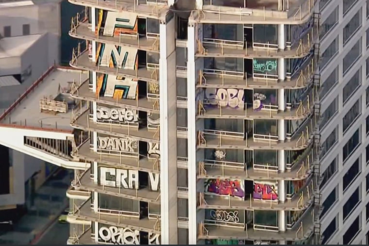 Graffiti covers multiple stories of a downtown Los Angeles high-rise.