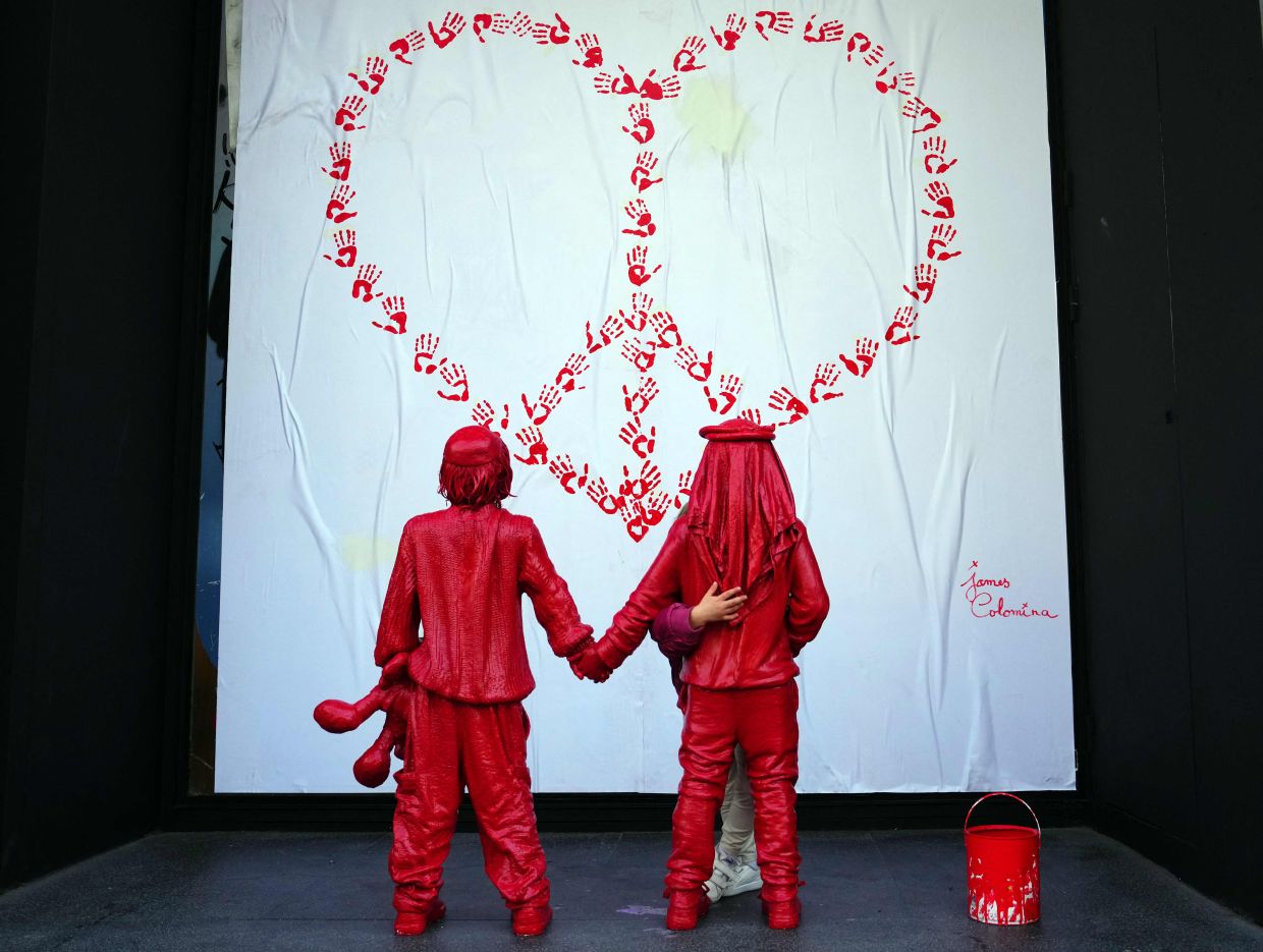 A child (right) hugs the installation created by Colomina in Barcelona. Photo: AFP