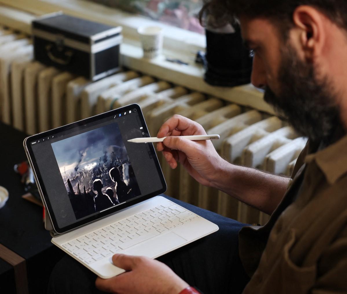Tabiyeci shows one of his drawings on a screen with the silhouettes of children facing a city devastated by the earthquake.