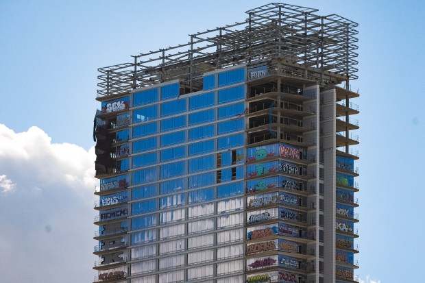 An unfinished high-rise development in the downtown entertainment district that...