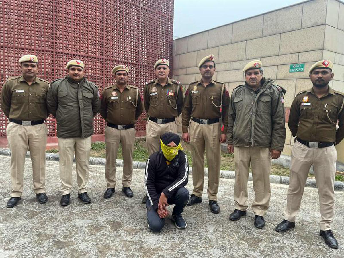 Delhi Police officers with a man arrested for allegedly painting slogans like ‘Delhi Banega Khalistan’.