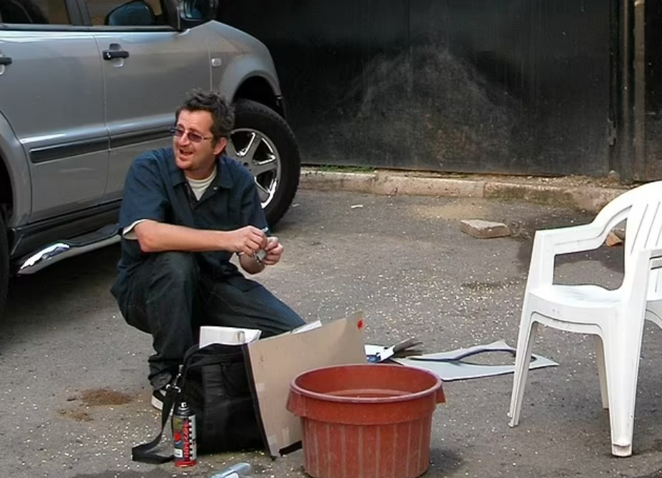 A snap believed to be Robin Gunningham, aka Banksy, painting in Jamaica in 2004