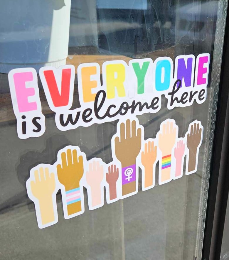 The sticker on the window of The Evergreen Coffee Lounge the store's co-owner says was defaced with a large 'X' written in thick marker.