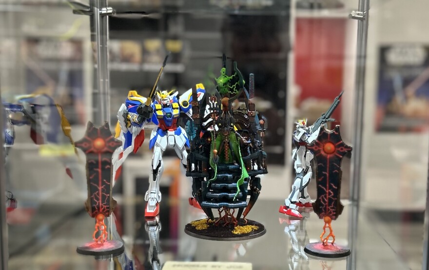 Collectible figures in a glass case. 