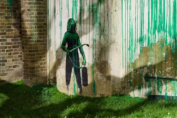 The mural features a stencil which is a classic hallmark of Banksy's style
