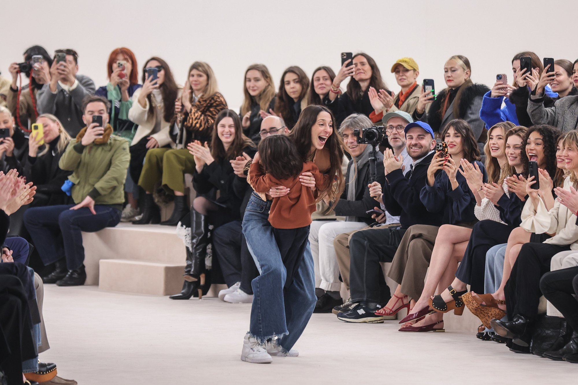Chloé’s creative director Chemena Kamali hugs her child at the end of the autumn/winter 2024 show in Paris. Photo: EPA-EFE