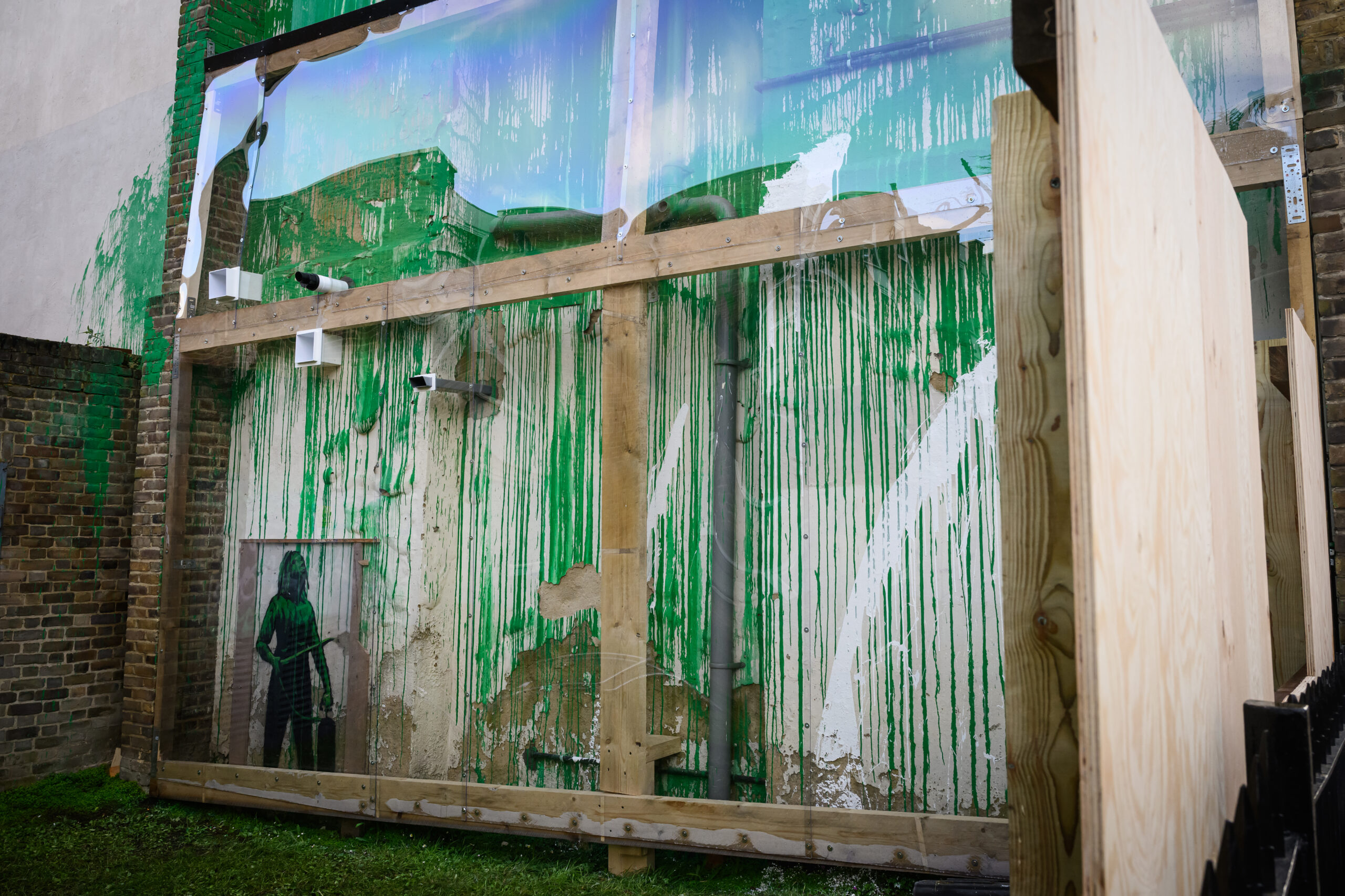 Security fencing, wooden hoardings and plastic screens surround the latest work by street artist Banksy