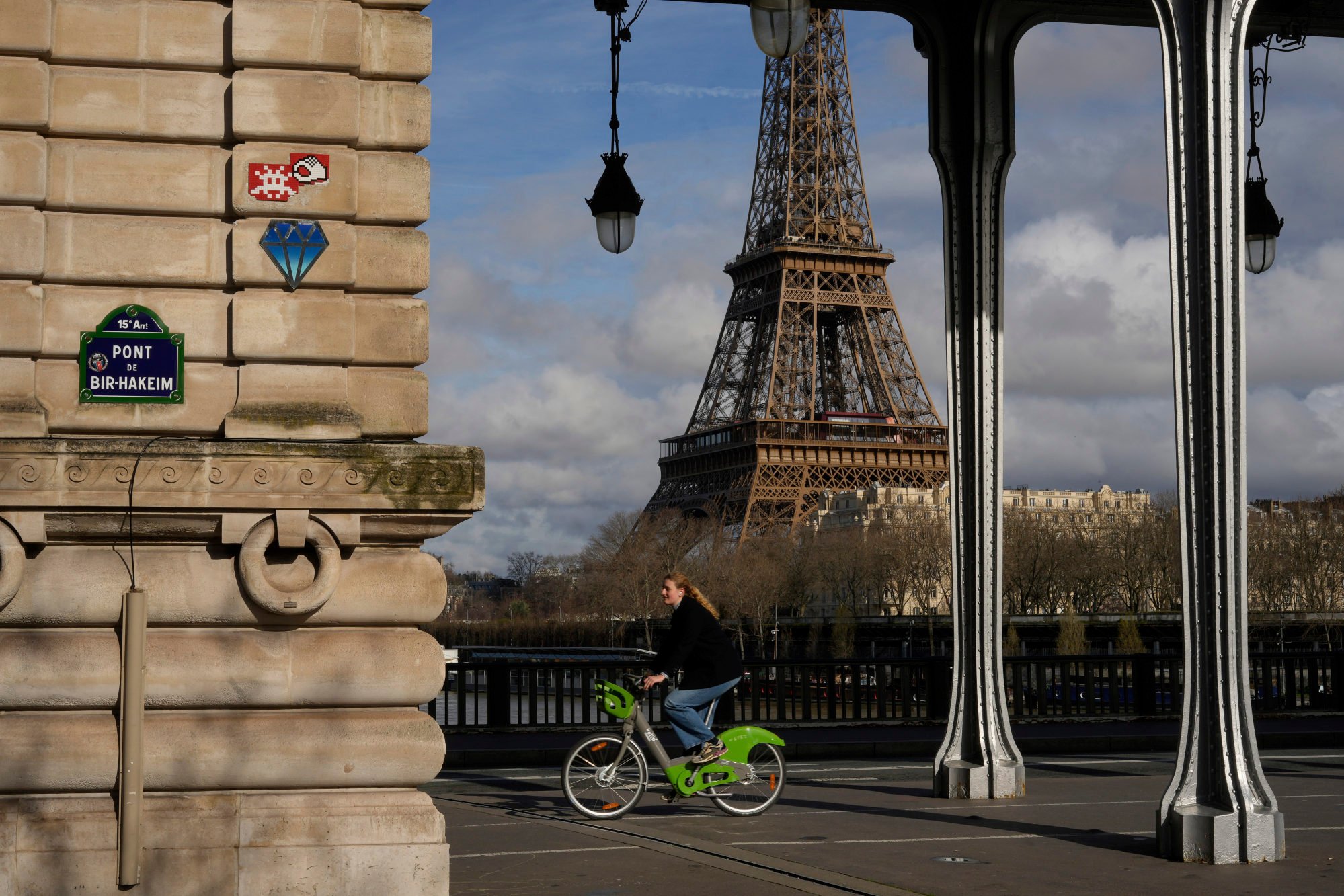 A red mosaic by Invader on a stone wall near the Eiffel Tower. Photo: AP