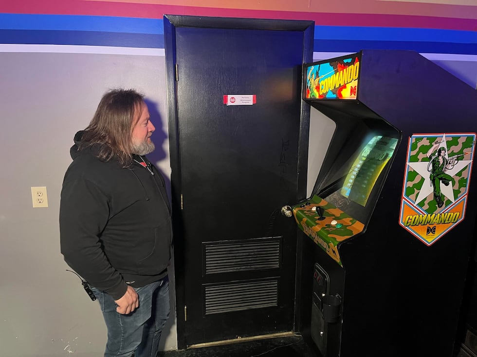 Aftershock Classic Arcade Bar owner looks at graffiti that was drawn on his gaming screens...
