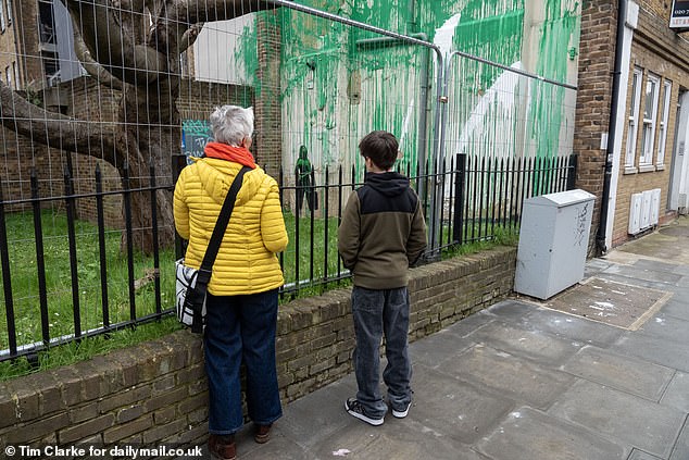 Passers-by have flocked to see the daubing - and were also today looking at the vandal damage