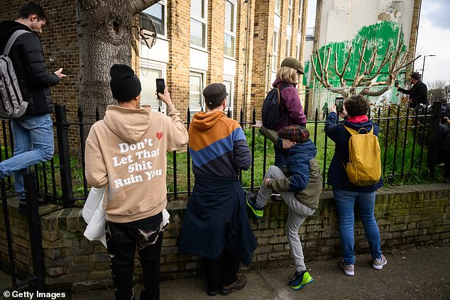 Despite the vandalism, fans of the anonymous street artist flocked to see the new addition to the mural following the vandalism with white paint