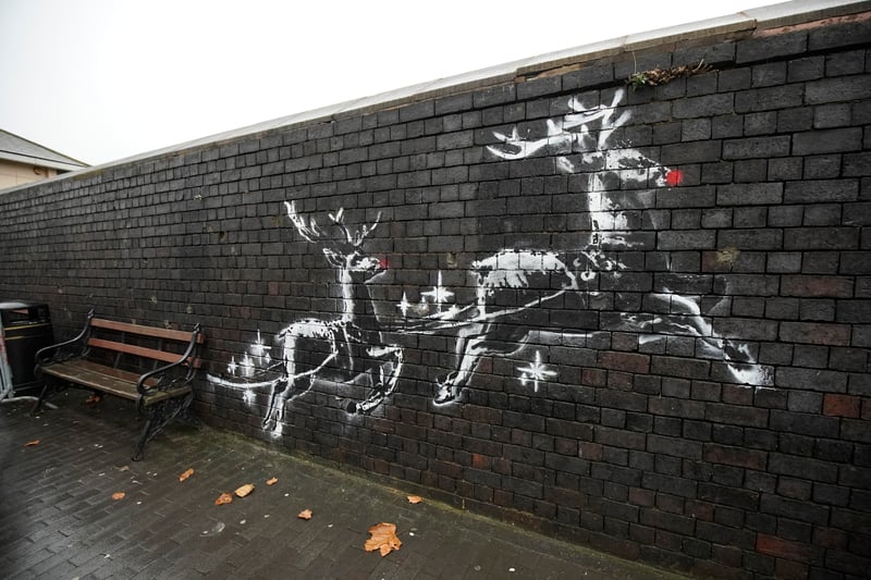 Banksy’s mural, located at Jewellery Quarter and created in December 2019, features two large reindeer pulling a bench behind them. The emotional and socially relevant artwork raises awareness about homelessness. Tourists often sit on the “Banksy Bench” to appreciate this powerful piece.