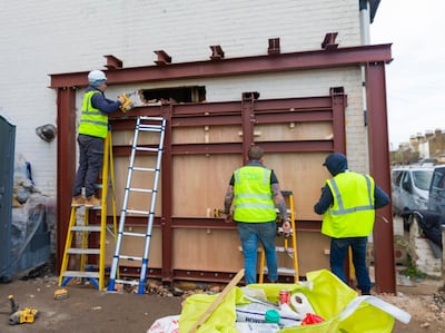 Workers cut around Banksy's Valentine's Day Mascara in Margate. Photo: Red Eight Gallery