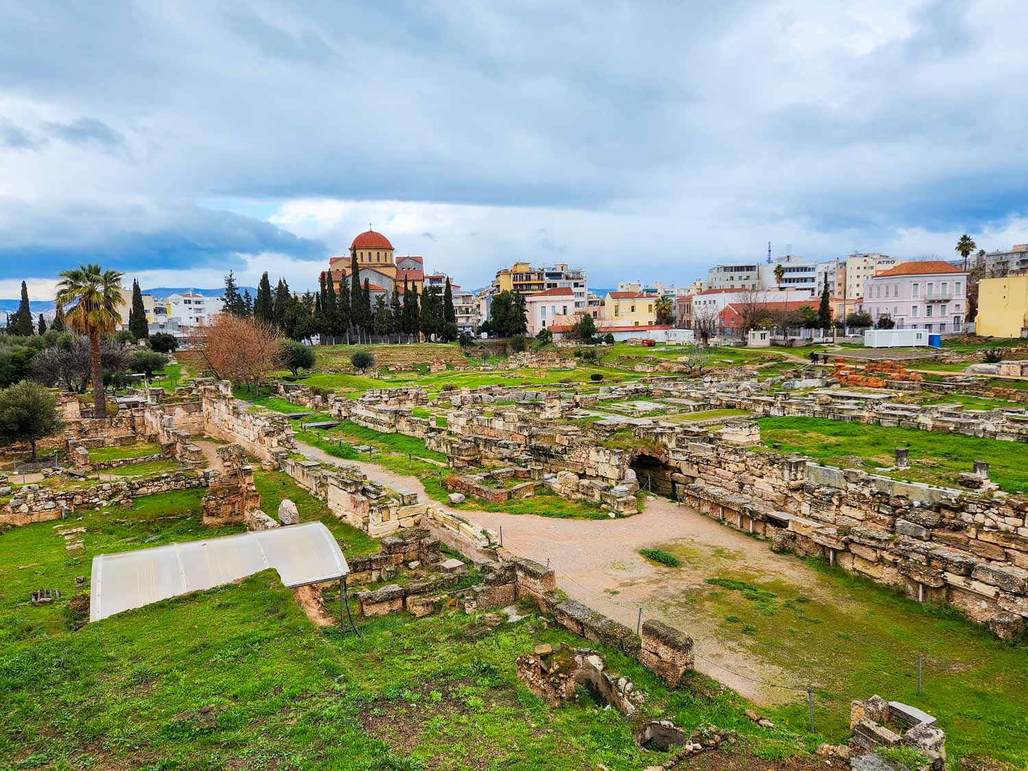 View over the ruins of Kerameikos, once the potters' quarter by the old city wall of Athens on a cloudy day - one of the stops on our street art tour of Athens