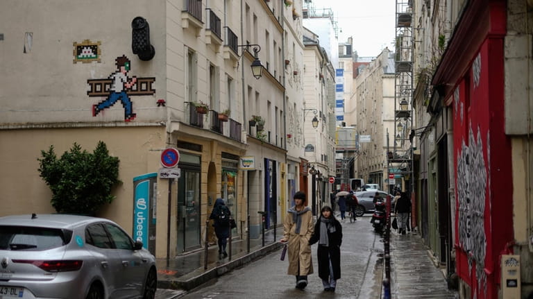 A mosaic by French artist Invader, top left, is seen...