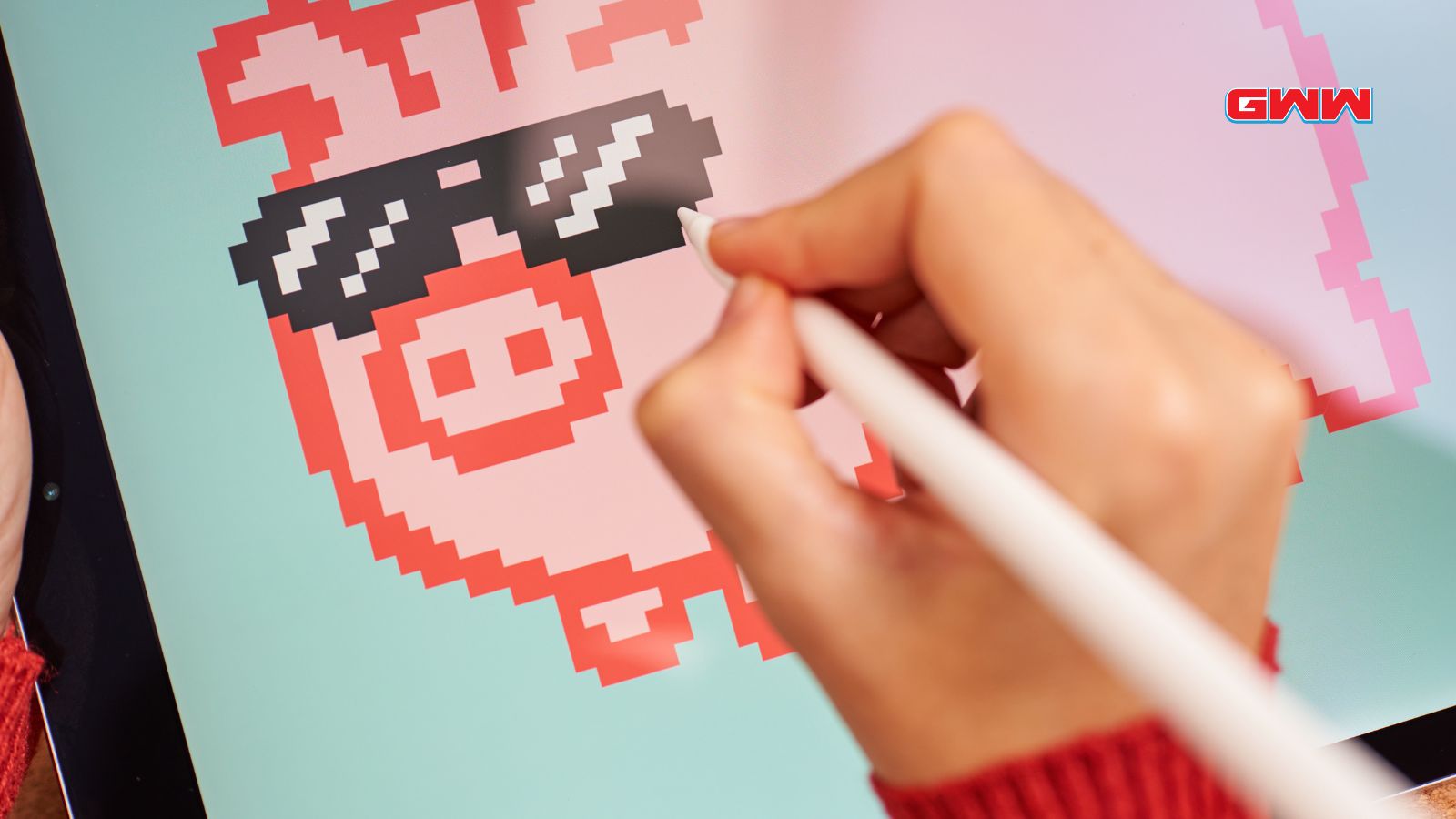Close up of hands painting digitally on a tablet creating NFT