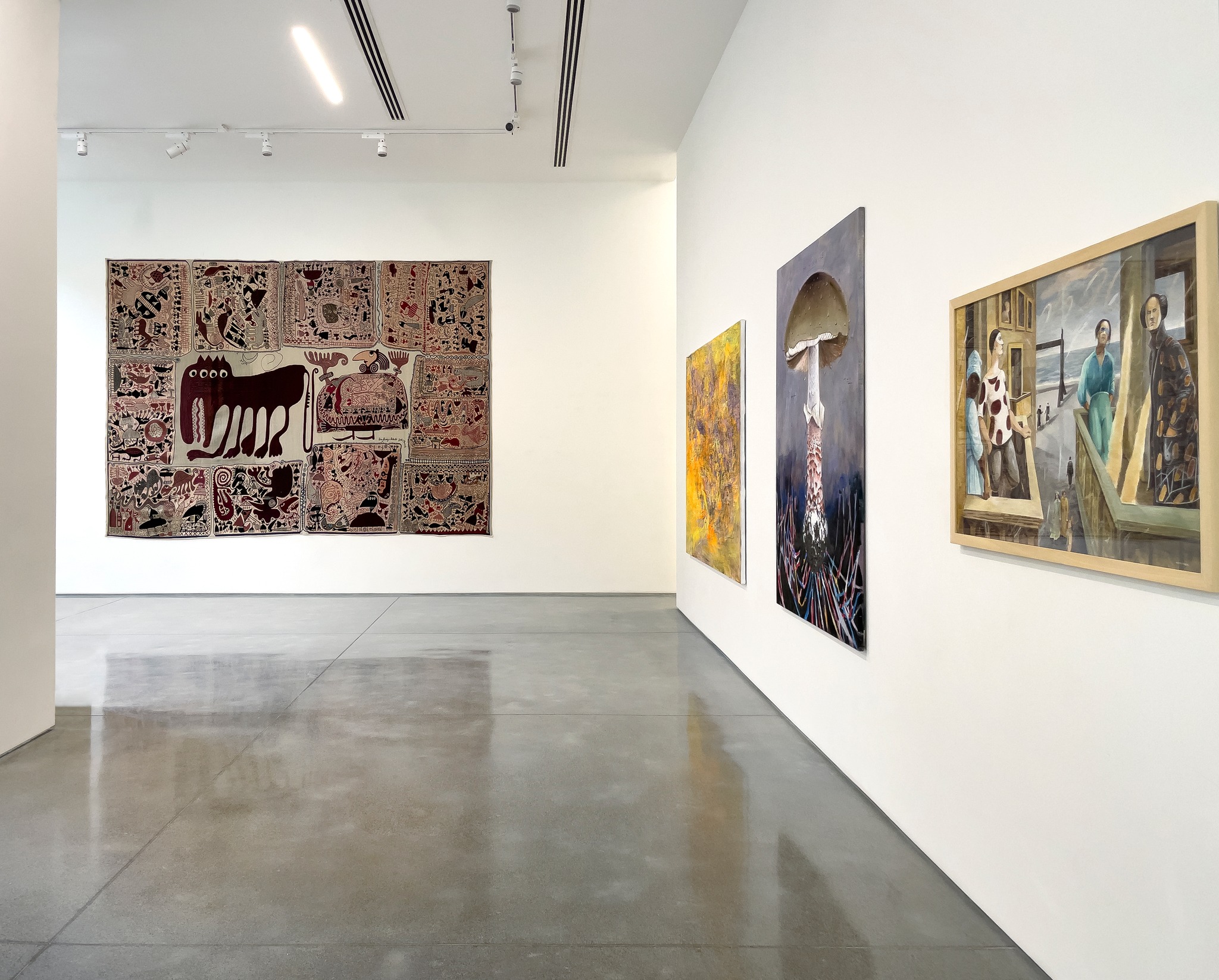 The interior of an art gallery with large art on the walls