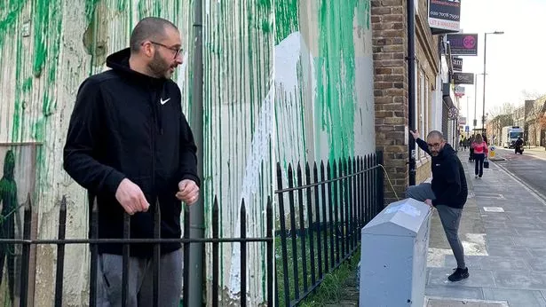 A man wearing a black hoodie was also spotted near the mural